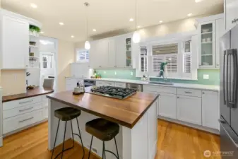 Kitchen right off the dining room has a generous island with counterseating