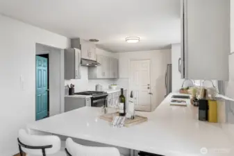 Kitchen has been updated; newer cabinetry, quartz counters, and stainless appliances.