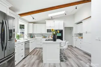 Flooded with natural light. New skylights, all appliances stay, new dishwasher. garage and laundry through the door on the right