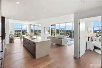 Spacious and open floor concept living + dining room with floor to ceiling windows.
