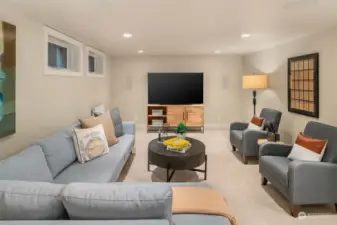 Generous lower-level media room with 1/2 bath.