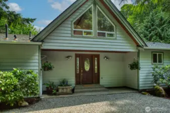 Welcoming entry under covered porch area.