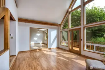 Living room opens to the dining space and deck.