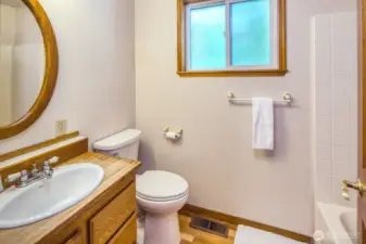 Main floor 3/4 bathroom with new toilet and newly refinished hardwoods.