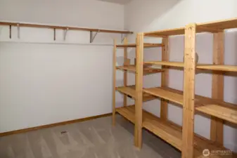 Walk in closet with the lower bedroom suite.