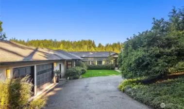 Wonderfully private estate setting with paved drive and 3 car garage.