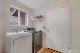 Washer and dryer stay! Door to the garage and a sink on the right side.