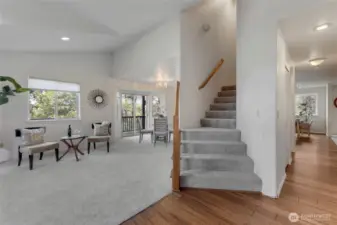 Living Room with new carpet. Stairs to the upper level!