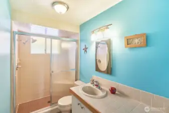 Bathroom with tiled shower.