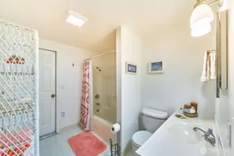 Full bathroom leads to garage, an easy way to clean up before entering the house