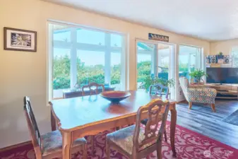 Dining area adjacent to kitchen with slider to south deck.