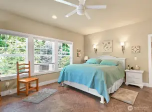 The Primary Bedroom is atthe back of the house looking out to the private grounds.  Large walk-in closet to the right .