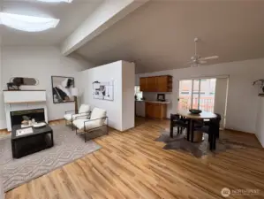 Step inside to a bright, open-concept living and dining area—designed for easy flow and everyday comfort, with a peek into the efficient galley kitchen just beyond.