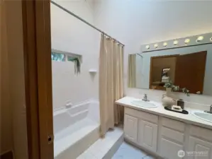 A gentle step into the wide tub makes getting in and out a breeze—combining comfort and practicality in this thoughtfully designed bathroom.