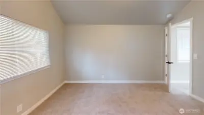 The primary suite features a deep closet with ample storage, private bathroom with barn door, vaulted ceiling and more!