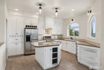 Updated granite island kitchen, new lighting, updated cabinets, hardware & faucet.