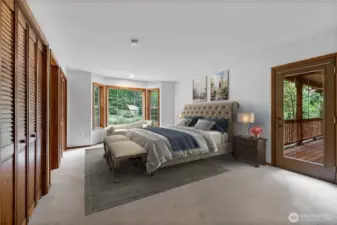 Primary bedroom with deck and views of nature! Virtually staged.