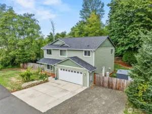 Corner lot, storage shed, fenced back yard, concrete parking apron...