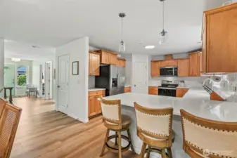 Eating peninsula with pendants flanks the U-shape kitchen...