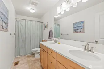 Full bath w/comfort height cabinetry, dual sinks and quartz countertops...