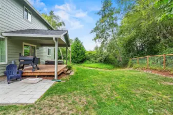 Covered cedar deck for grilling out of the weather, large fenced back yard plus pavered patio...