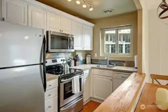 Great cabinet space, track lighting, and open to Living/Dining.
