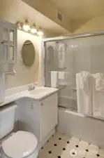 Full bathroom. Bath/shower with glass doors.