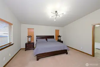 Spacious primary bedroom suite with adjacent 5-piece bath and two walk-in closets.