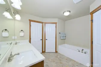 5-piece primary ensuite with Quartz countertops and cherry wood cabinets.