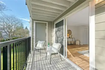 Covered balcony with newer deck and metal railings. Easy access to private storage closet.