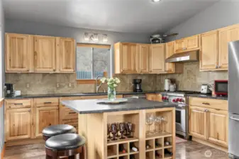 The kitchen island is a great gathering spot with built-in wine storage.
