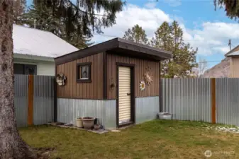 A custom garden shed was designed to match the home and keeps all of your tools organized and out of sight.