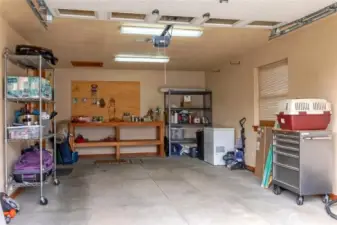 The spacious one car garage with automatic door has workbench and lots of storage room.