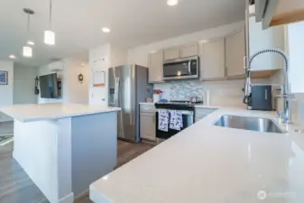 Spacious kitchen with island seating and quartz countertops
