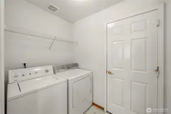 Utility room off of kitchen with door to garage