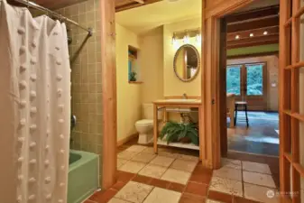 Full bath with ceramic tiled floor. Washer & Dryer are to your right, just beyond the right edge of this photo. Walk- in-closet is to your back.