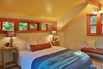 Windows and vaulted ceilings up here as well! A fun mix of warm wood tones and color will bring a smile to your face. The floor up here is carpeted.