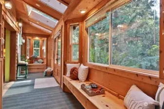 Sweet window seat to the right with a huge window. Straight ahead is another window seat, perfect spot for a table for two. The propane stove is to your back.