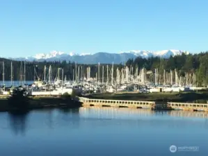 The majestic Olympic Mountains rise over the Port Ludlow Marina and Bay. The marina is welcome to the public.