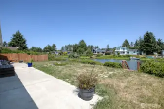 Spacious concrete slab off backyard for entertaining.