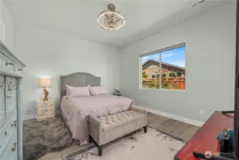 Primary bedroom with the stunning lighting fixture/ceiling fan Engineered hardwoods, custom blinds and a fresh coat of paint.  Easily can accommodate a King size bed with two bedside tables.