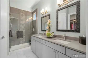 Primary bath offers Quarts counters, custom framed mirrors, tiled shower and flooring. Upgraded hardware as well.