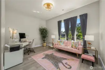 The guest en-suite offers a private sitting room, full bath, kitchenette and walk-in closet w/ built ins. The high-end chandelier is a great touch! A lovely spot for guests or family to retreat to. Their own private suite!