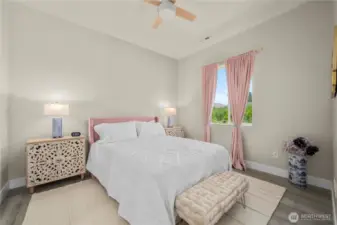 The second bedroom with adjacent sitting room offers your guests or family their own private space!  Engineered hardwoods and custom ceiling fan.