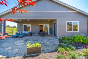 Huge flagstone patio overflows from the covered patio.  This home is begging to host friends and family!  Immense privacy and no home to the East!