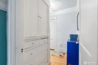 Connected to the Dining room, a hallway leads to the main floor bathroom, bedroom and stairs to the second floor