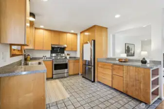 This home offers open concept main-level living with hardwood floors, new lighting & updated  kitchen w/tile floor, newer gas range w/pot filler & dishwasher.