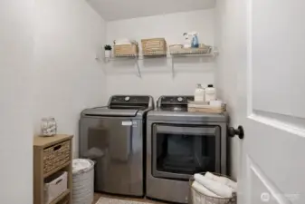 Virtually staged laundry room - washer and dryer stay