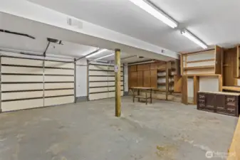 Oversized garage with storage and shop benches.