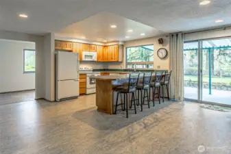 Here's the kitchen, dining room, patio door, covered patio, and back yard beside the waterfront.